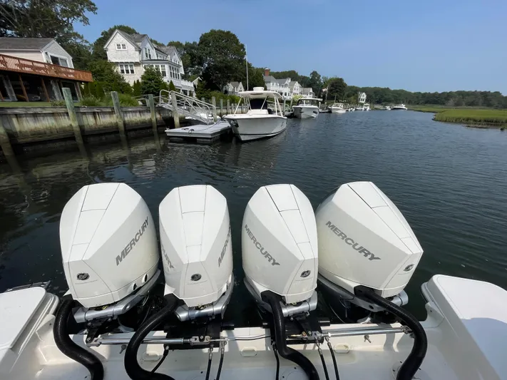 Sea Cure Yacht Photos Pics 2021 Boston Whaler 405 Conquest with four Mercury engines docked in a scenic marina.
