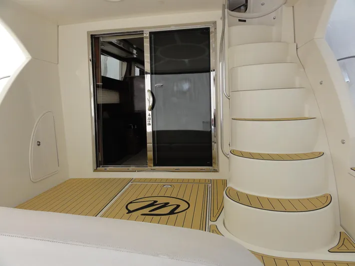  Yacht Photos Pics 2009 Meridian 441 Sedan yacht interior with spiral staircase and sliding glass door.