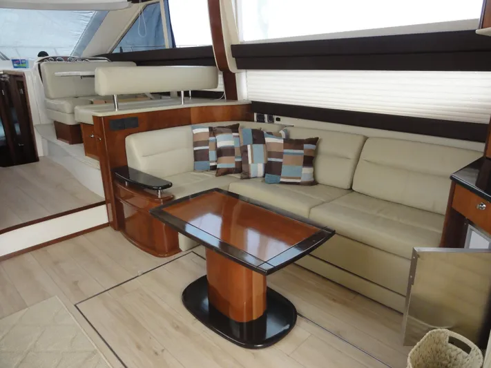  Yacht Photos Pics Luxurious interior of 2009 Meridian 441 Sedan yacht with beige seating and wooden table.