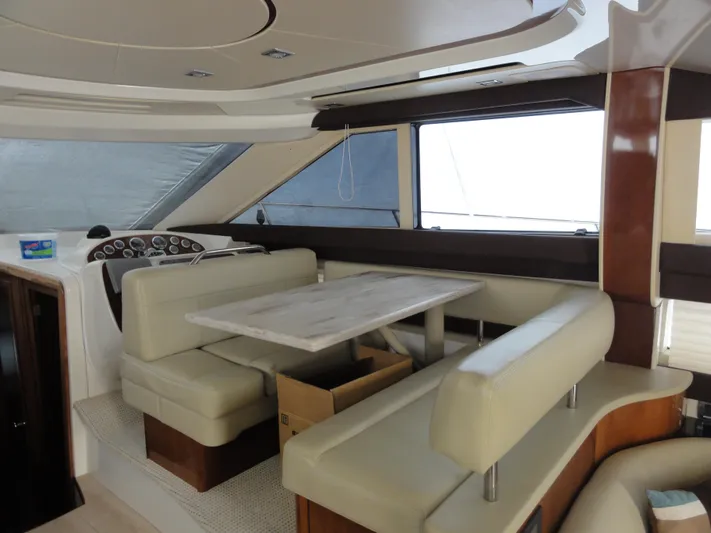  Yacht Photos Pics Interior of 2009 Meridian 441 Sedan yacht with beige seating and dining table.