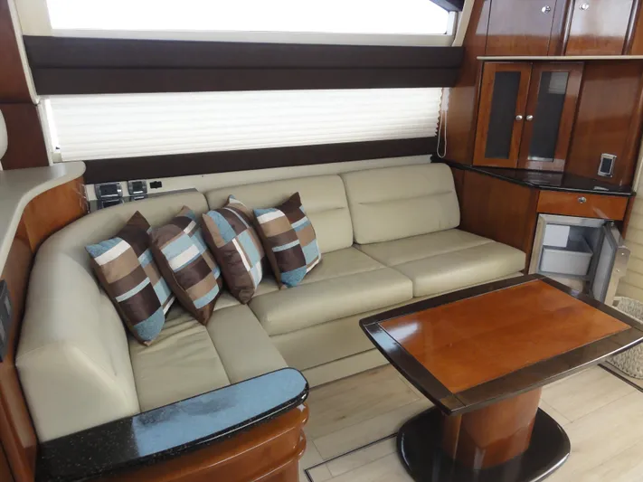  Yacht Photos Pics Luxurious interior of 2009 Meridian 441 Sedan with beige sofa and wooden table.