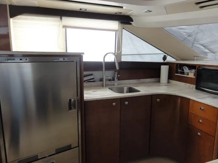  Yacht Photos Pics 2009 Meridian 441 Sedan yacht kitchen with stainless steel appliances and modern cabinetry.