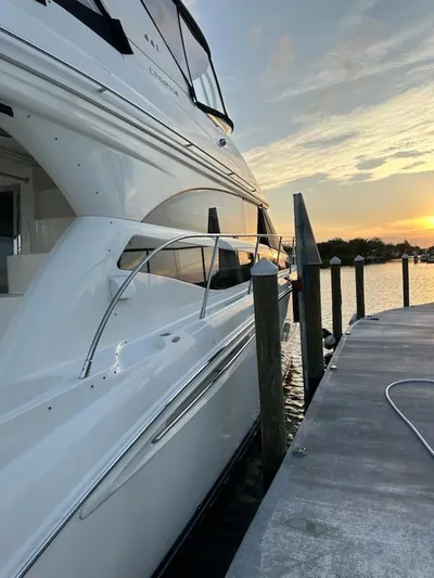  Yacht Photos Pics 2009 Meridian 441 Sedan yacht docked at sunset, showcasing sleek design and luxury.