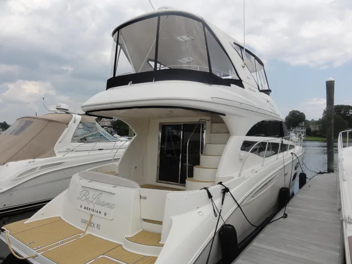 Yacht Photos Pics 2009 Meridian 441 Sedan yacht docked at marina, featuring sleek design and spacious deck.