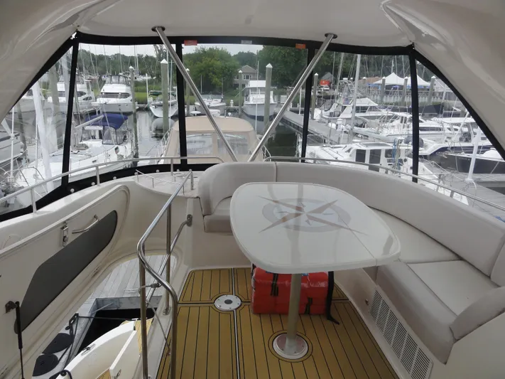  Yacht Photos Pics 2009 Meridian 441 Sedan yacht interior with seating and table, docked at marina.