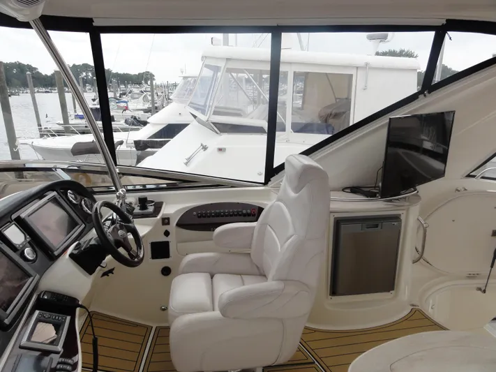  Yacht Photos Pics Interior of 2009 Meridian 441 Sedan yacht with helm, seating, and marina view.