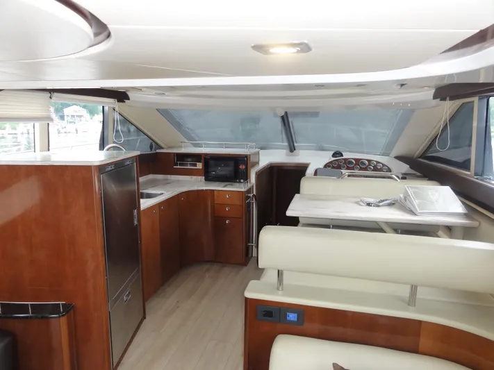  Yacht Photos Pics Luxurious interior of a 2009 Meridian 441 Sedan yacht with modern kitchen and seating area.