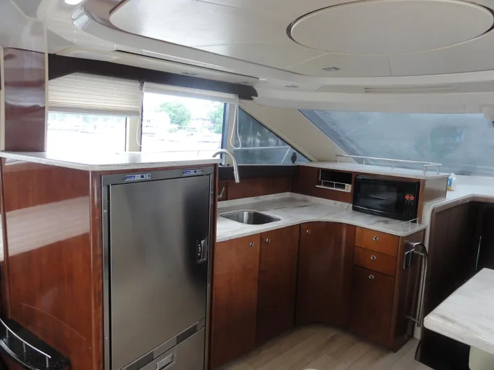  Yacht Photos Pics Luxurious kitchen interior of 2009 Meridian 441 Sedan yacht with modern appliances.