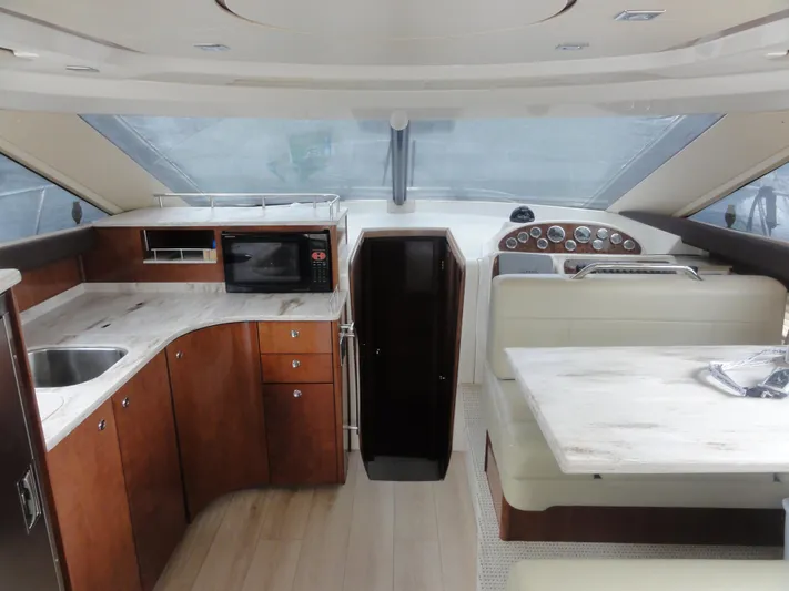 Yacht Photos Pics Interior of 2009 Meridian 441 Sedan yacht with kitchen and dining area.