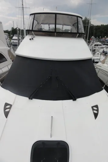 Yacht Photos Pics 2009 Meridian 441 Sedan yacht docked at marina, front view with covered windshield.