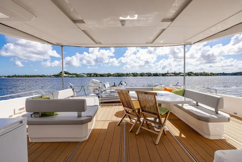 Nautilus Yacht Photos Pics Leopard 53 Powercat 2021 yacht deck with seating, overlooking serene water and sky.
