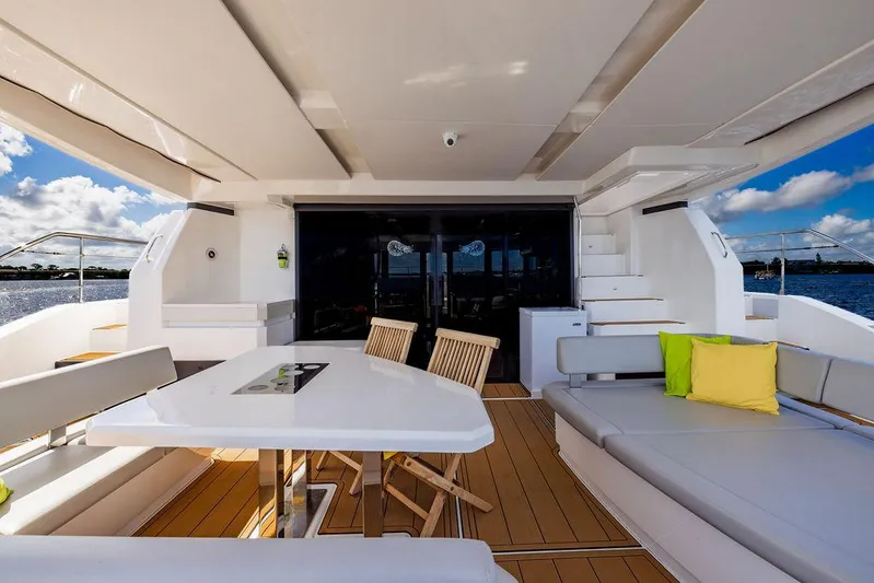 Nautilus Yacht Photos Pics Luxurious 2021 Leopard 53 Powercat yacht deck with seating, table, and ocean view.