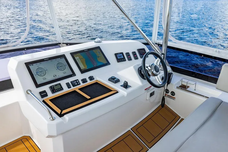Nautilus Yacht Photos Pics Helm of 2021 Leopard 53 Powercat with modern navigation displays and steering wheel.