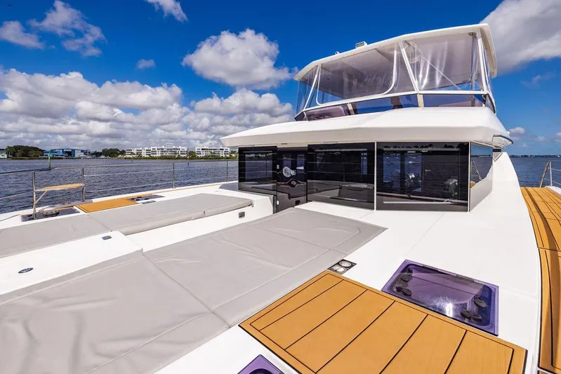 Nautilus Yacht Photos Pics 2021 Leopard 53 Powercat yacht with spacious deck and modern design on a sunny day.