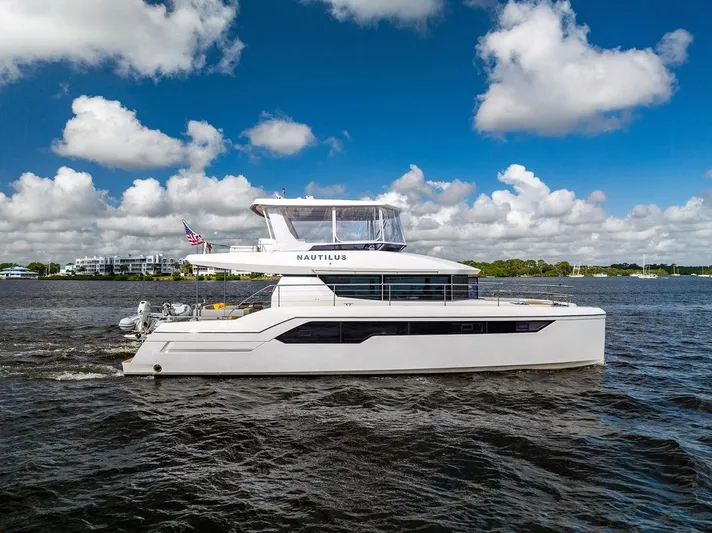 Nautilus Yacht Photos Pics 2021 Leopard 53 Powercat yacht cruising on a sunny day with blue skies and clouds.