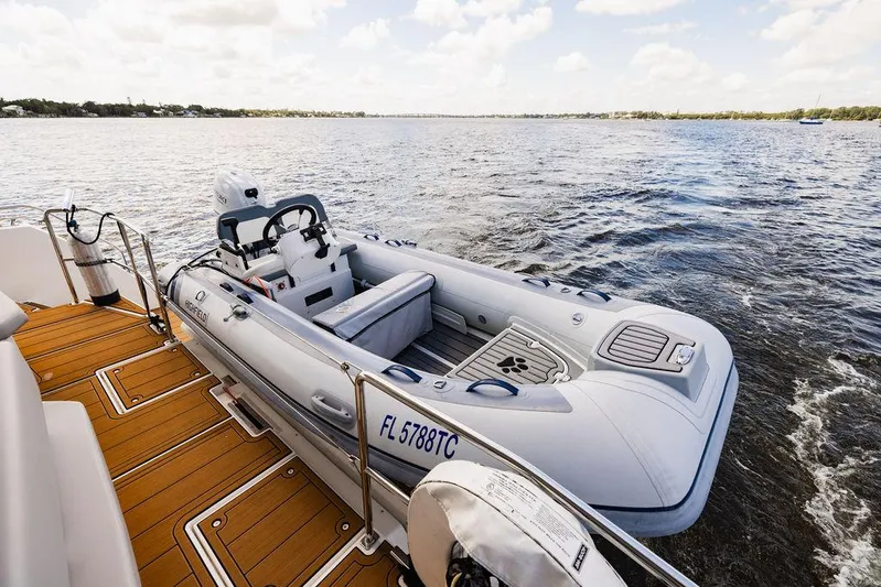 Nautilus Yacht Photos Pics 2021 Leopard 53 Powercat with inflatable boat on deck, cruising on calm waters.