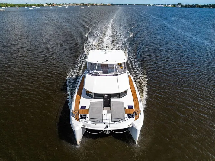 Nautilus Yacht Photos Pics 2021 Leopard 53 Powercat cruising on open water, aerial view.
