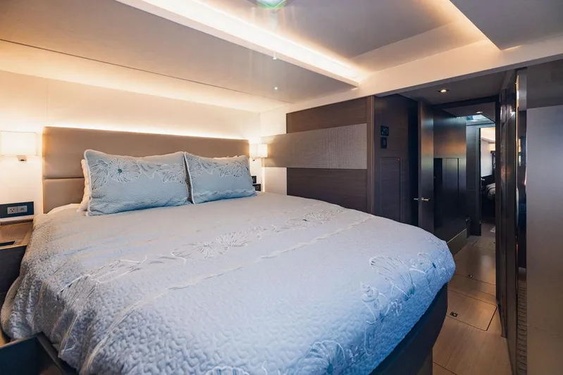 Nautilus Yacht Photos Pics Luxurious bedroom interior of 2021 Leopard 53 Powercat yacht with elegant lighting and bedding.