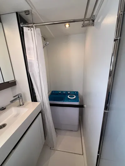 Nautilus Yacht Photos Pics 2021 Leopard 53 Powercat bathroom with shower, sink, and compact washing machine.