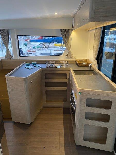 Modern kitchen area in 2024 Lagoon 42 catamaran with ample counter space.