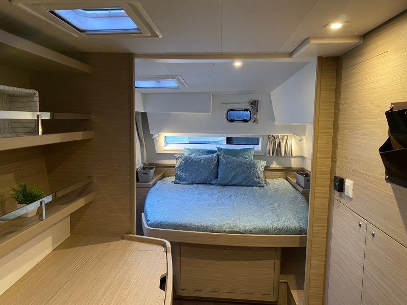 2024 Lagoon 42 catamaran interior cabin with bed and skylights.