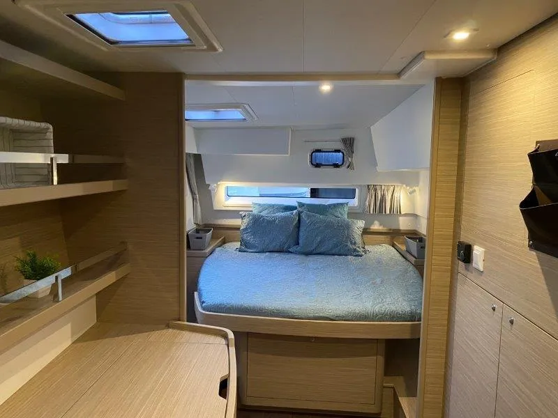 2024 Lagoon 42 catamaran interior cabin with bed and skylights.