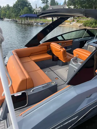  Yacht Photos Pics 2016 Cruisers Yachts 338 SOUTH BEACH with orange seating, docked by a scenic lakeside.