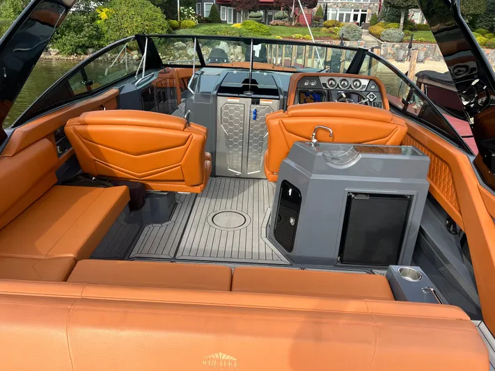  Yacht Photos Pics 2016 Cruisers Yachts 338 SOUTH BEACH interior with orange seating and modern dashboard.