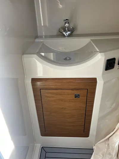  Yacht Photos Pics 2016 Cruisers Yachts 338 SOUTH BEACH bathroom sink with wooden cabinet.