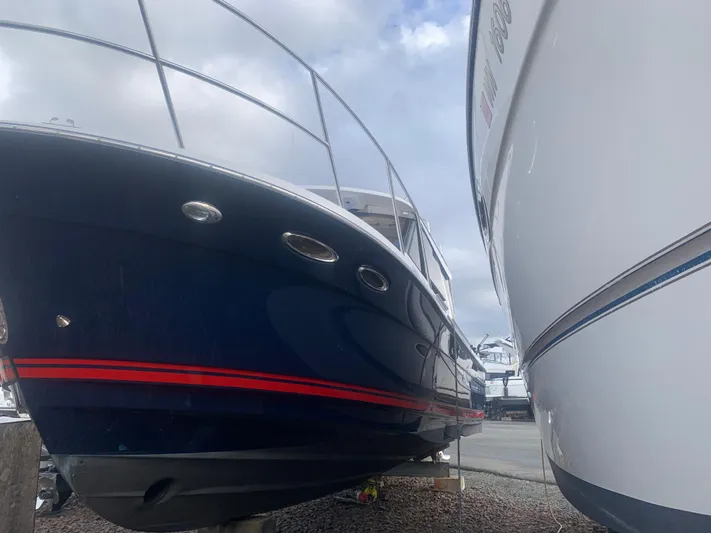  Yacht Photos Pics 2018 Cutwater C 302 Coupe boat docked next to another vessel.