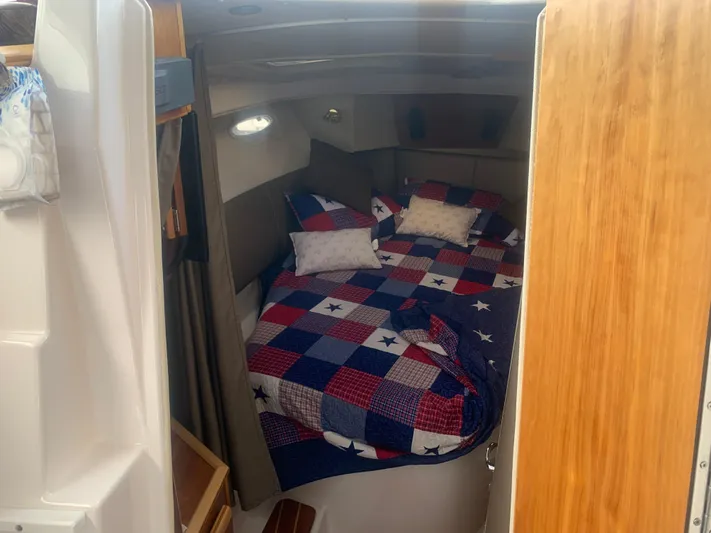  Yacht Photos Pics 2018 Cutwater C 302 Coupe cabin with a cozy bed and colorful quilt.
