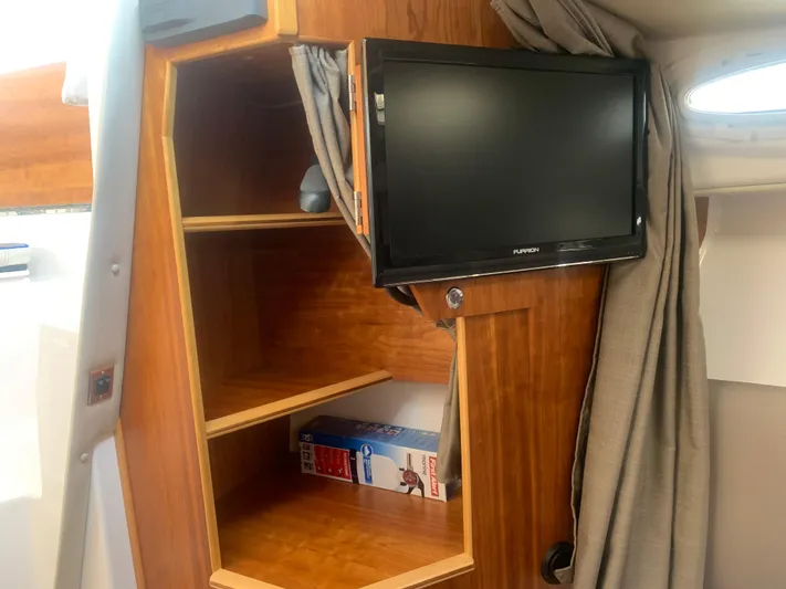  Yacht Photos Pics 2018 Cutwater C 302 Coupe interior with TV and wooden shelves.