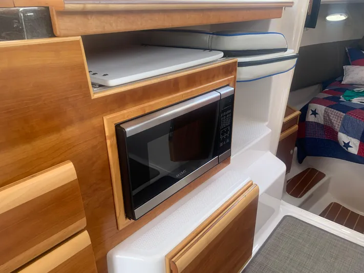  Yacht Photos Pics 2018 Cutwater C 302 Coupe interior with microwave and cozy cabin.