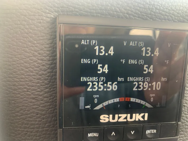  Yacht Photos Pics Suzuki engine display on a 2018 Cutwater C 302 Coupe boat showing engine hours and voltage.