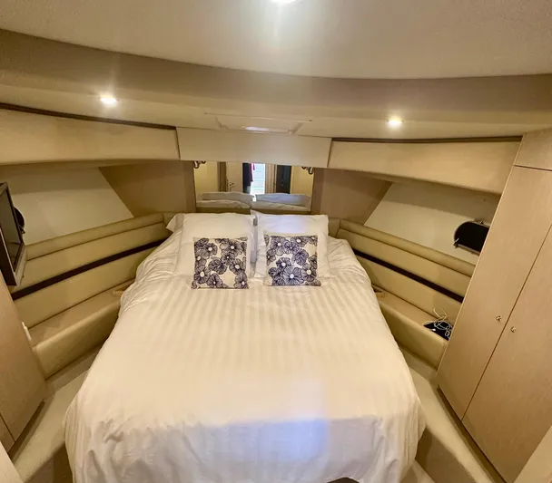 Mi Amore Yacht Photos Pics Luxurious bedroom interior of 2006 Ferretti Yachts 550 with elegant bedding and ambient lighting.