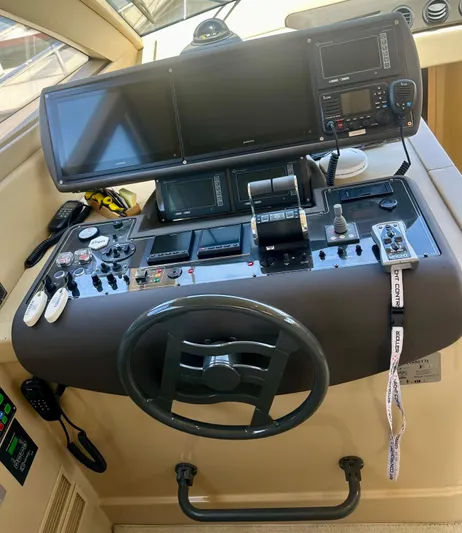 Mi Amore Yacht Photos Pics Helm of 2006 Ferretti Yachts 550 with navigation controls and steering wheel.
