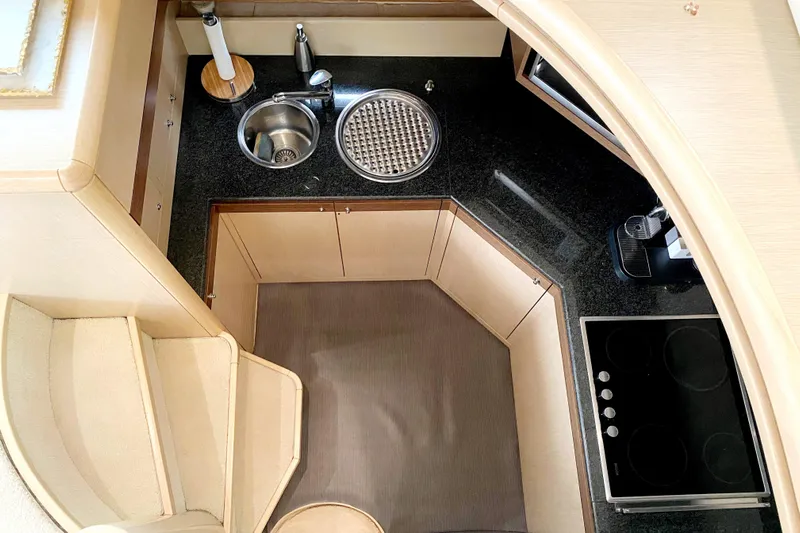 Mi Amore Yacht Photos Pics Compact kitchen area in a 2006 Ferretti Yachts 550, featuring modern appliances and sleek design.