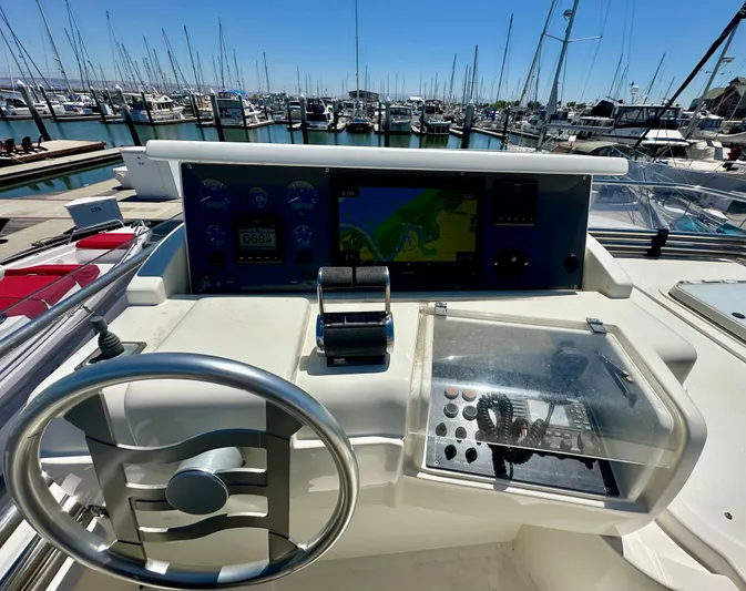 Mi Amore Yacht Photos Pics Helm of 2006 Ferretti Yachts 550 with navigation controls, docked at marina.