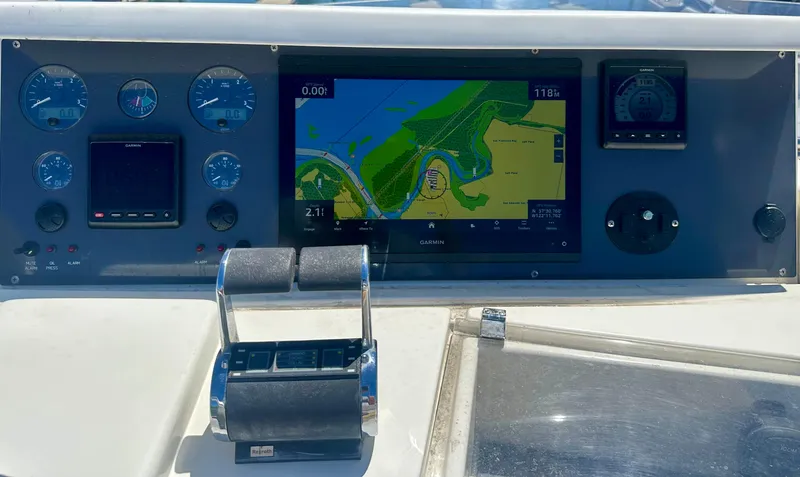 Mi Amore Yacht Photos Pics Control panel of a 2006 Ferretti Yachts 550 with navigation display and throttle levers.