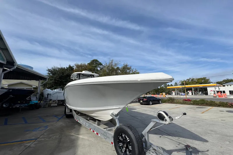  Yacht Photos Pics 2023 Fountain 38 Tournament Edition boat on trailer, parked outdoors under blue sky.