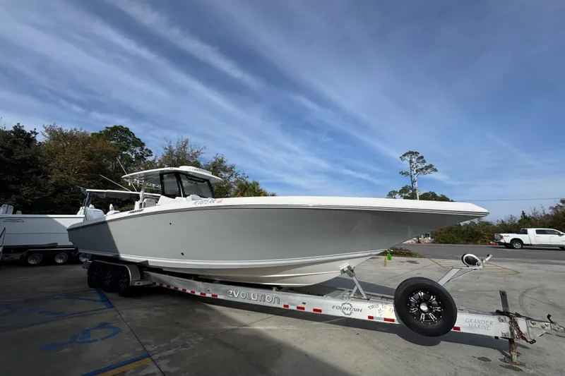  Yacht Photos Pics 2023 Fountain 38 Tournament Edition boat on trailer, parked outdoors under blue sky.