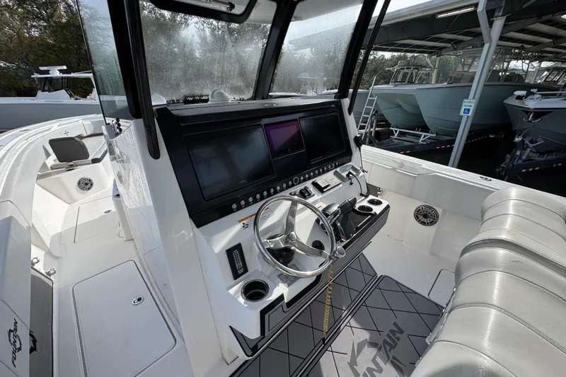  Yacht Photos Pics 2023 Fountain 38 Tournament Edition boat cockpit with modern controls and seating.
