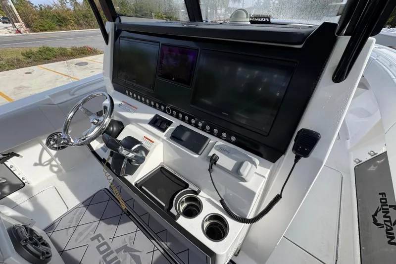  Yacht Photos Pics 2023 Fountain 38 Tournament Edition boat dashboard with steering wheel and electronic displays.