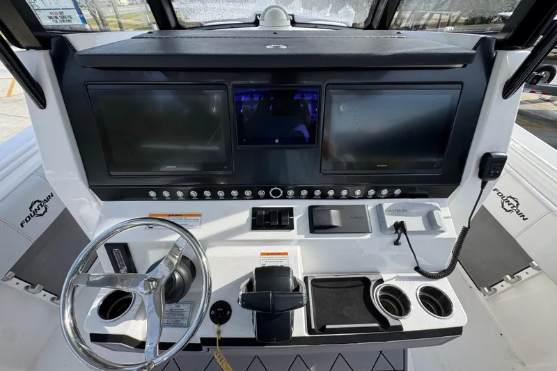  Yacht Photos Pics 2023 Fountain 38 Tournament Edition boat dashboard with dual Garmin displays and steering wheel.