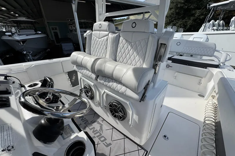  Yacht Photos Pics 2023 Fountain 38 Tournament Edition boat interior with luxurious seating and modern steering wheel.