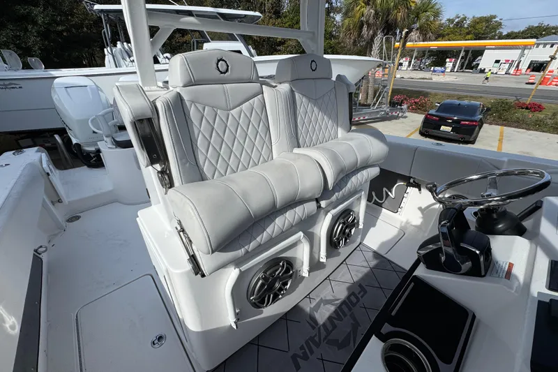  Yacht Photos Pics 2023 Fountain 38 Tournament Edition boat interior with luxury seating and steering wheel.