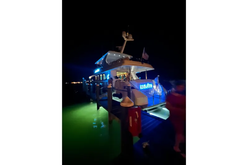 Mojito Yacht Photos Pics Luxury 2006 Hargrave Raised Pilothouse yacht docked at night with vibrant blue lighting.
