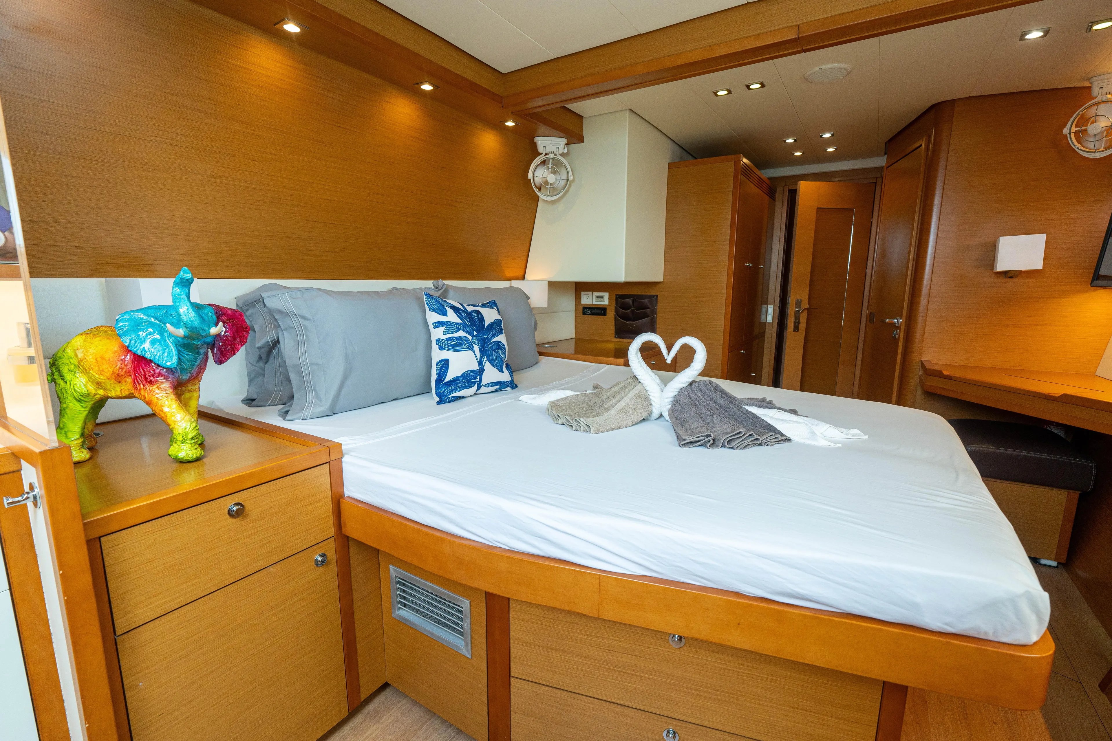 LibertÉ Yacht Photos Pics Luxurious cabin interior of 2011 Lagoon 560 yacht with elegant decor and cozy bedding.