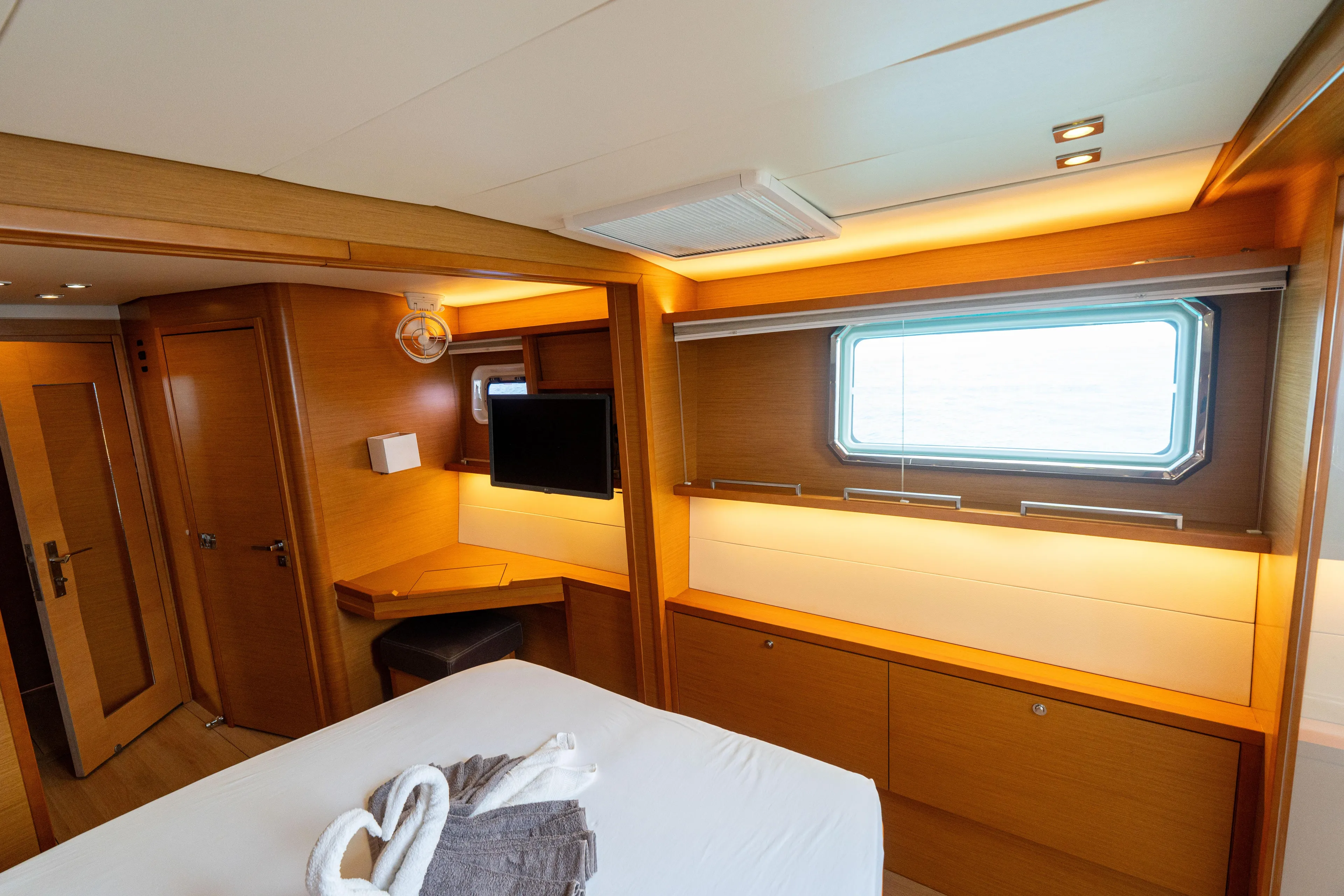 LibertÉ Yacht Photos Pics Luxurious cabin interior of 2011 Lagoon 560 yacht with modern amenities and elegant wood finish.