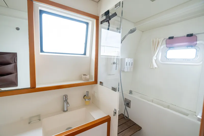 LibertÉ Yacht Photos Pics Luxurious bathroom in 2011 Lagoon 560 yacht with modern fixtures and natural light.